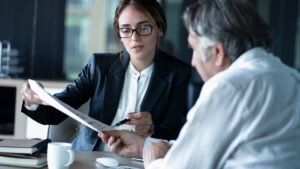 A Winston-Salem alimony lawyer going over paperwork with a client.