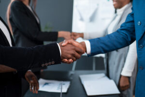 Two pairs of people shaking hands in an office in Winston-Salem.